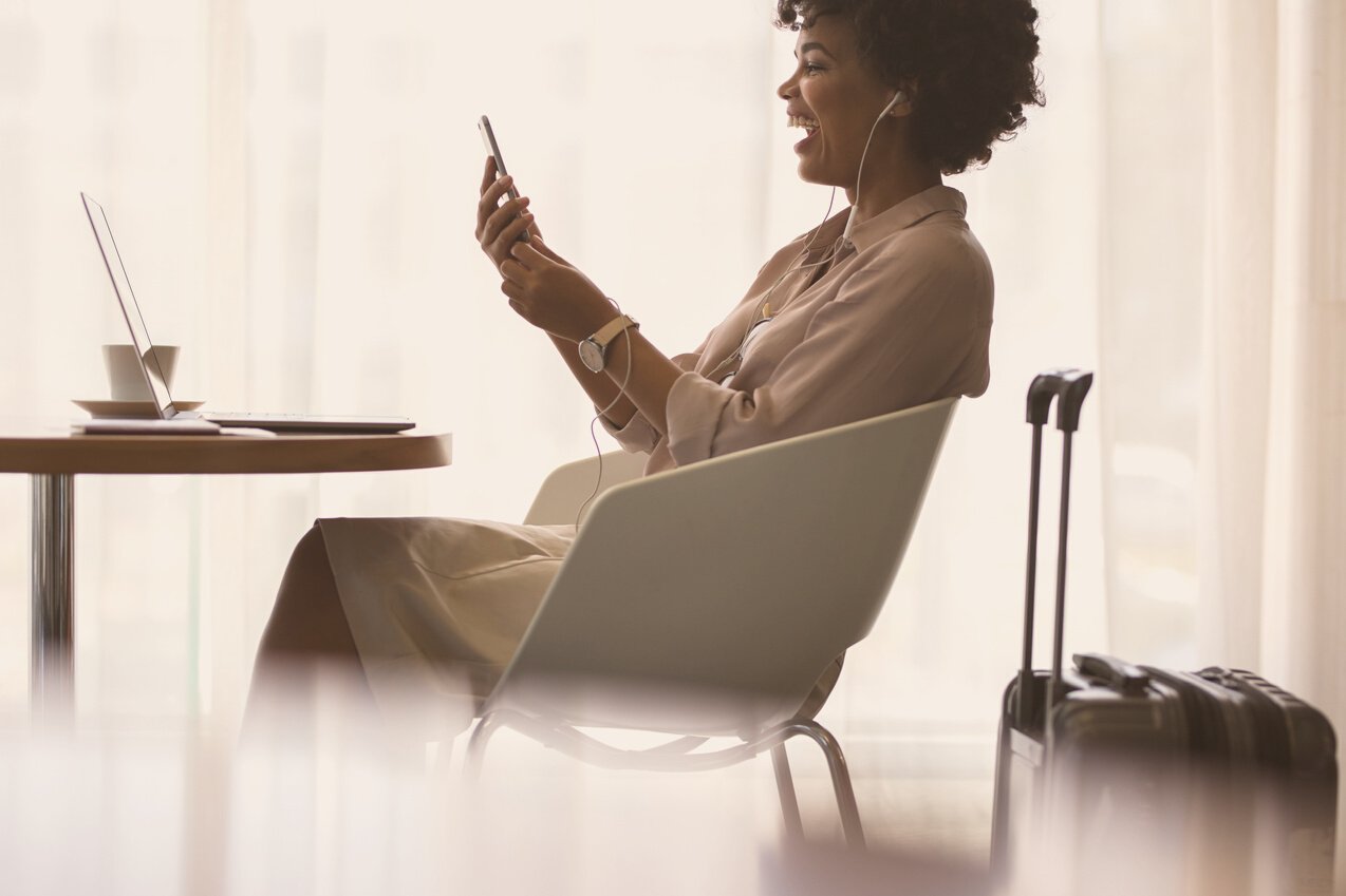 Businesswoman Making Video Call at Airport Lounge